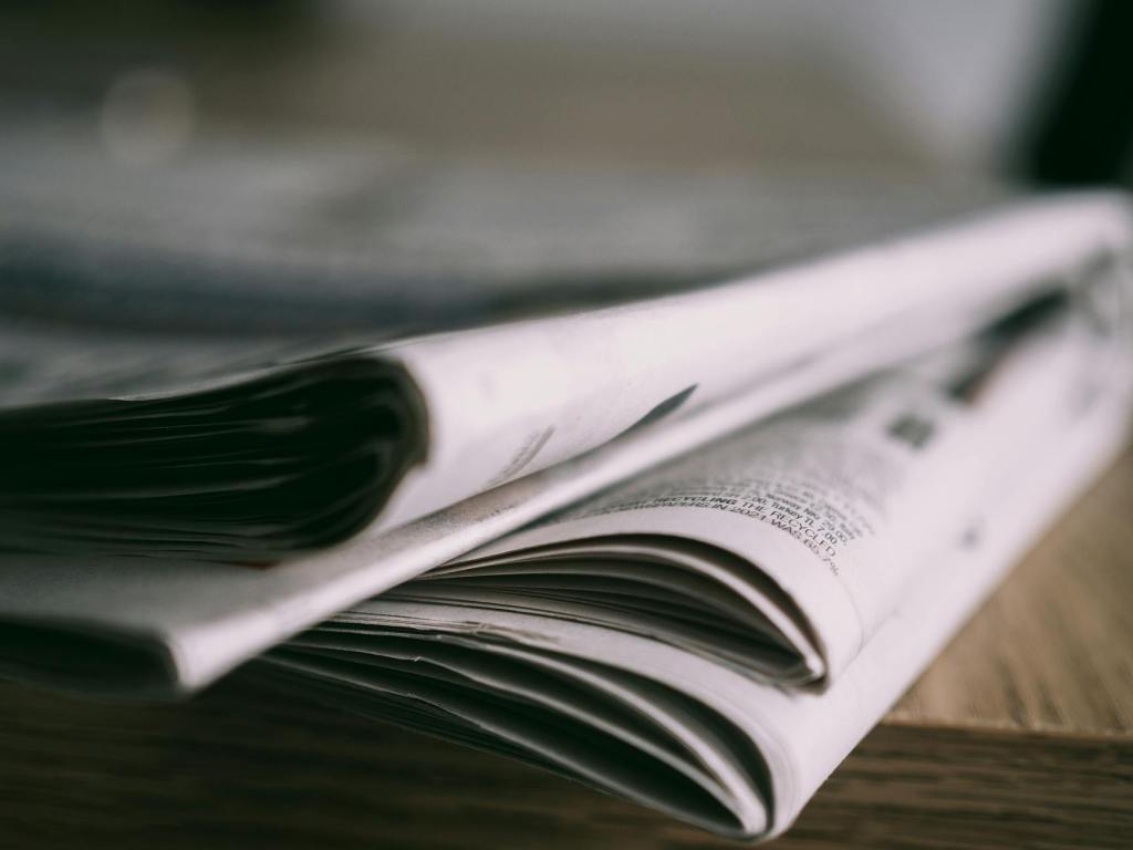 Close up of newspapers on wooden table